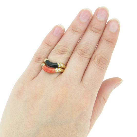 Cartier French 1970s 18KT Yellow Gold Coral, Diamond, Onyx Ring on finger